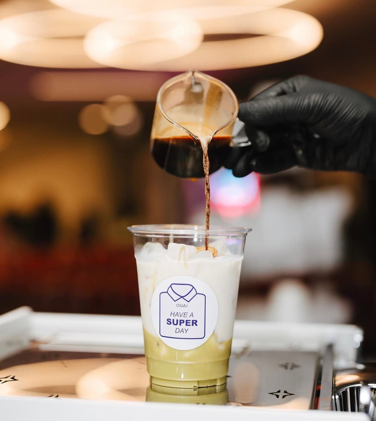 Pouring an OUAI signature drink